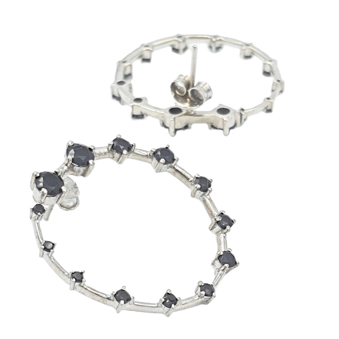 Back view of black onyx front-facing hoop earrings in rhodium-plated 92.5 sterling silver, showing the polished finish and backing.