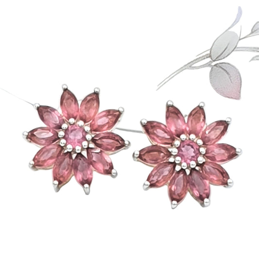 Pair of 925 sterling silver pink flower-shaped gemstone corundum earrings on a white background