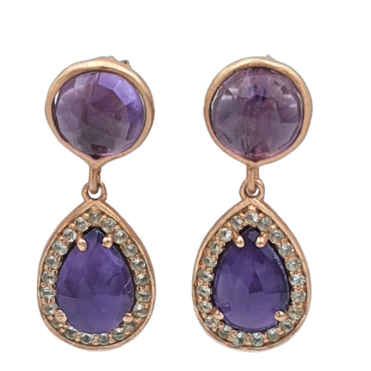 A pair of rose gold earrings featuring round Amethyst stones with a halo of White Topaz around each, set against a white background.