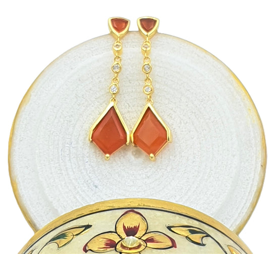 sterling silver earrings with gold plating earrings with onyx stones and white topaz stones on a decorative jewelry box