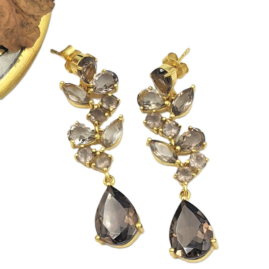 Gold plated 925 sterling silver earrings with smoky quartz stones on a white background