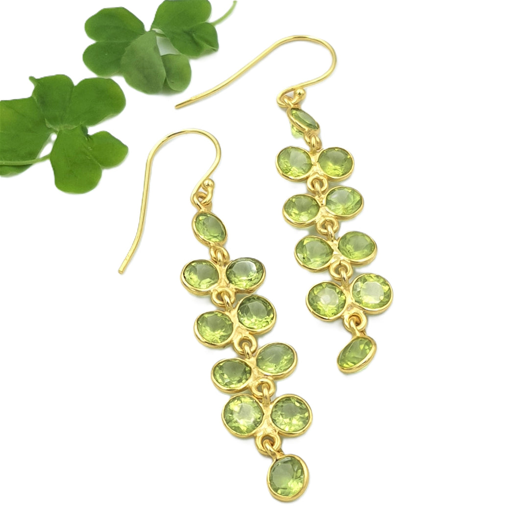 view of 925 sterling silver peridot gemstone earrings with yellow-gold plating, highlighting the green wisteria bloom detailing.