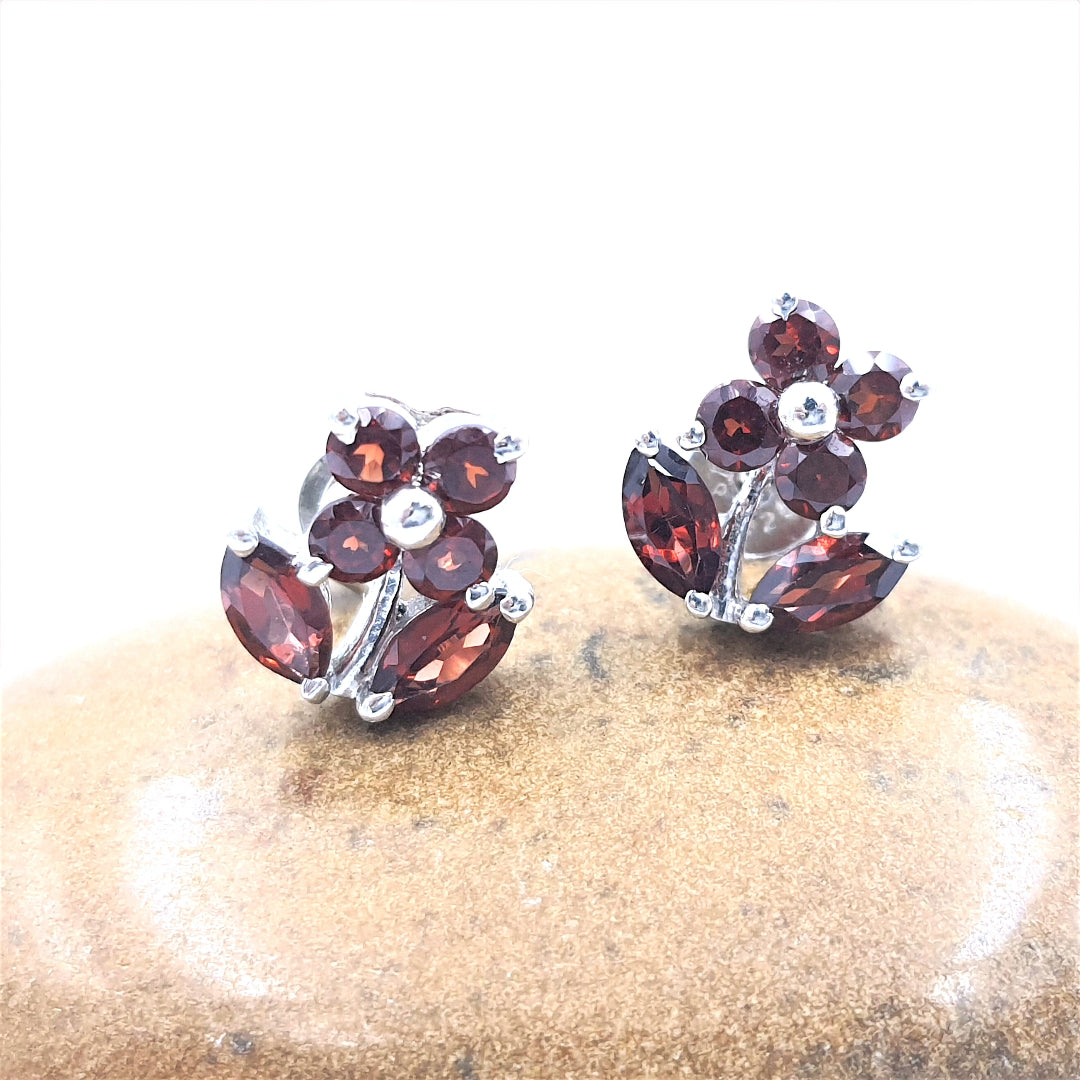 Garnet gemstone earrings crafted in 92.5 sterling silver with a rhodium finish, featuring a vibrant blossom-inspired design.