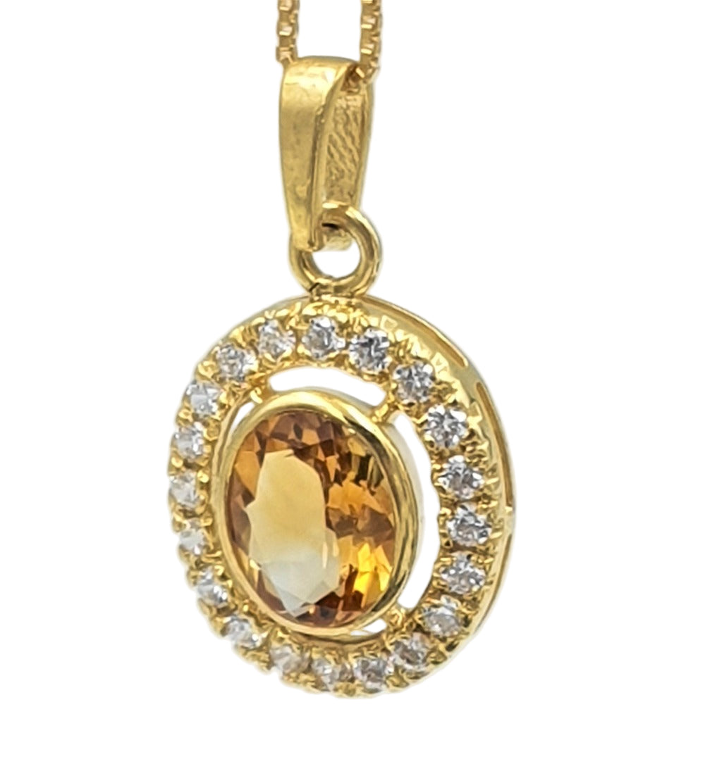 Detailed close-up of gold-plated pendant with citrine and cubic zirconia stones, showcasing the radiant yellow sparkle and fine craftsmanship.