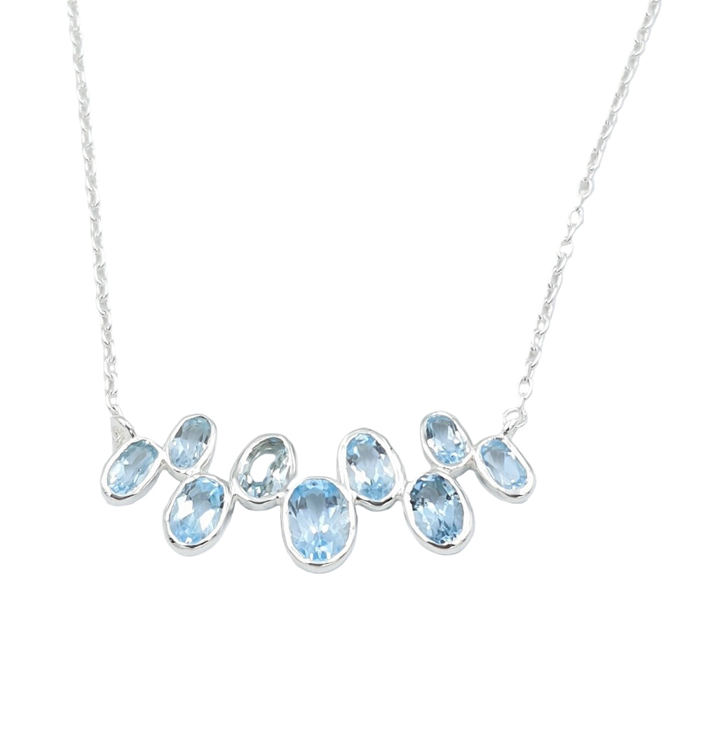 Detailed close-up of blue topaz stones set in sterling silver, showing their clarity and fine craftsmanship.