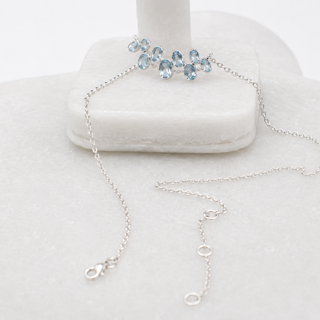 Blue Topaz silver necklace with 16-inch extendable chain, inspired by the serene beauty of blue lagoons.