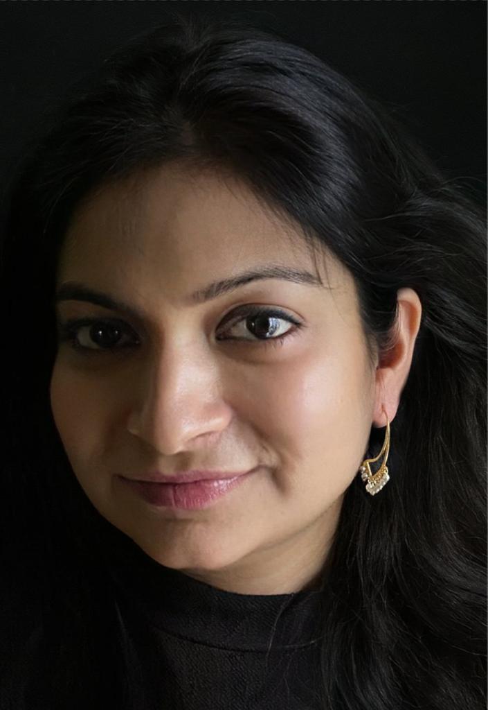 Swan-shaped pearl drop earrings in gold-plated 92.5 sterling silver worn by a woman, showing their playful, chic look when styled.