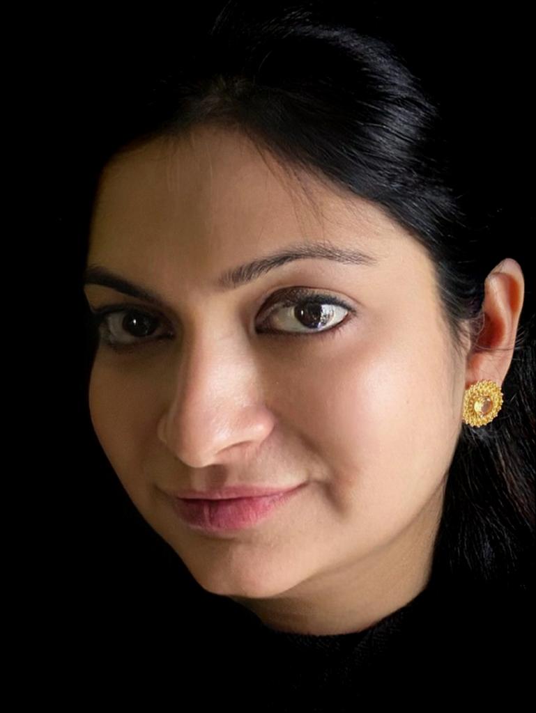 Citrine and white topaz earrings in gold-plated 92.5 sterling silver worn by a woman, showing their radiant sun-inspired look when styled.