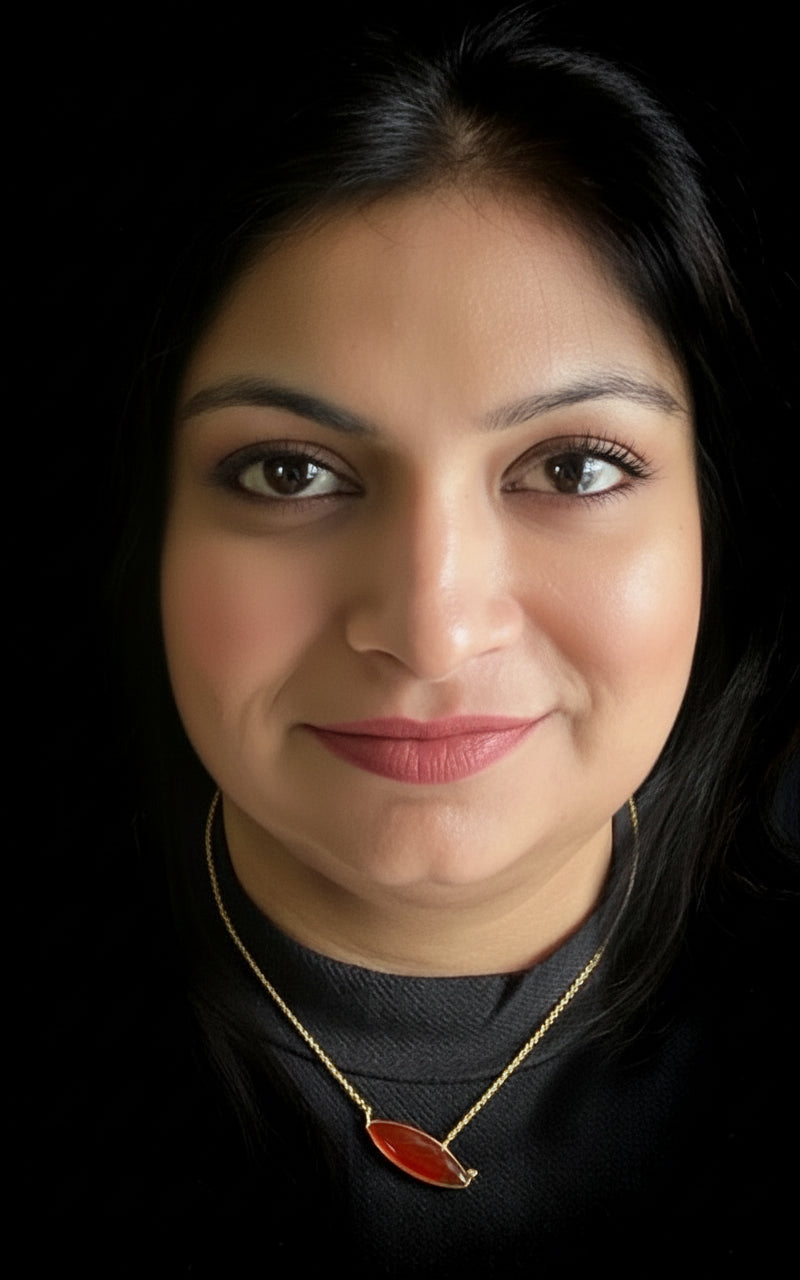 Red onyx and peridot pendant necklace in gold-plated 92.5 sterling silver worn by a woman, showing its bold, artistic look when styled.