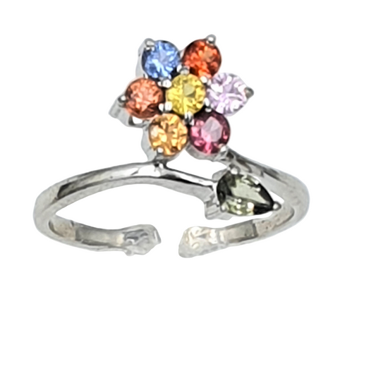 An adjustable finger ring with a floral design, featuring multi-colored sapphire stones set in a silver band.