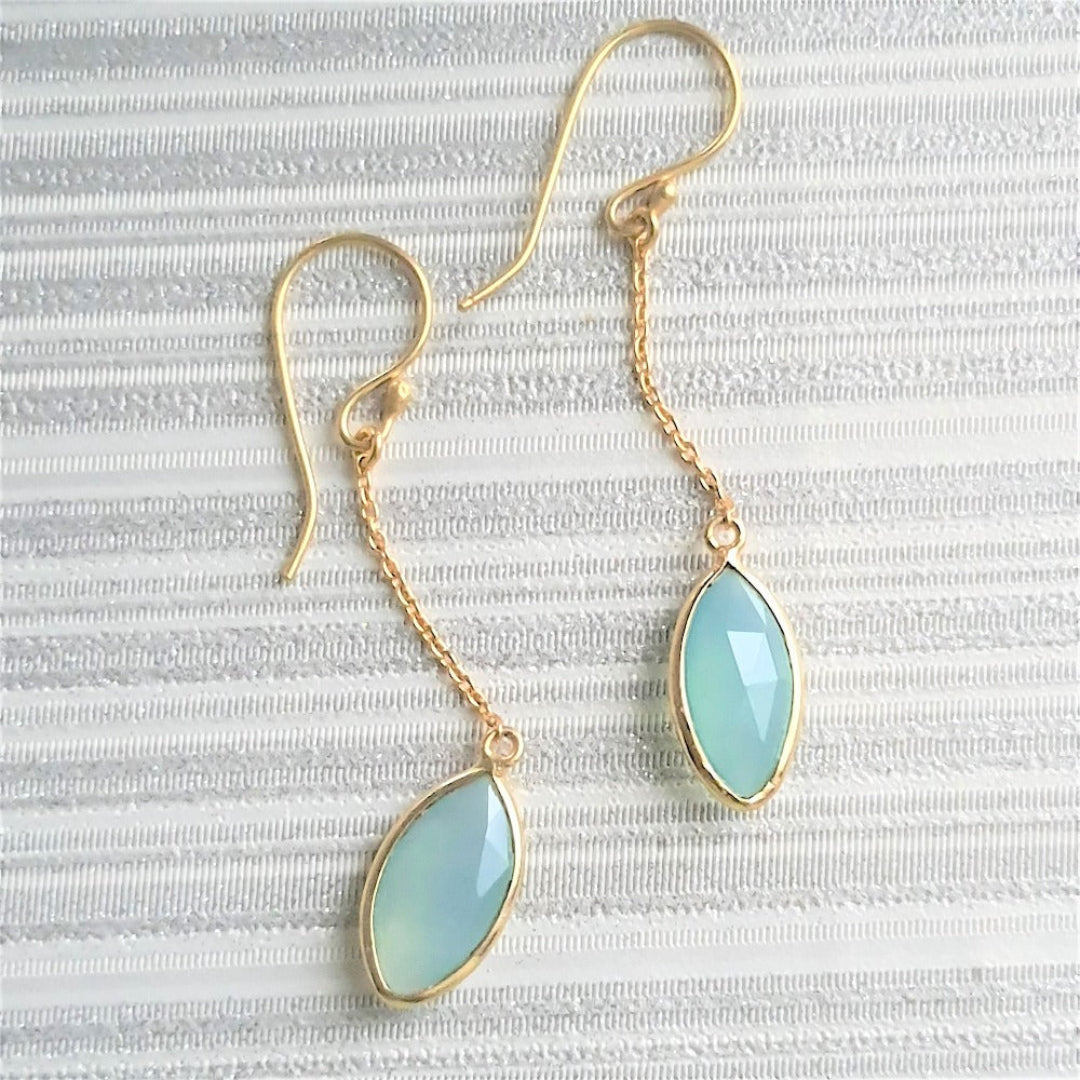 Gold-plated 92.5 sterling silver earrings featuring aqua chalcedony stones, showcasing their soft oceanic blue glow.