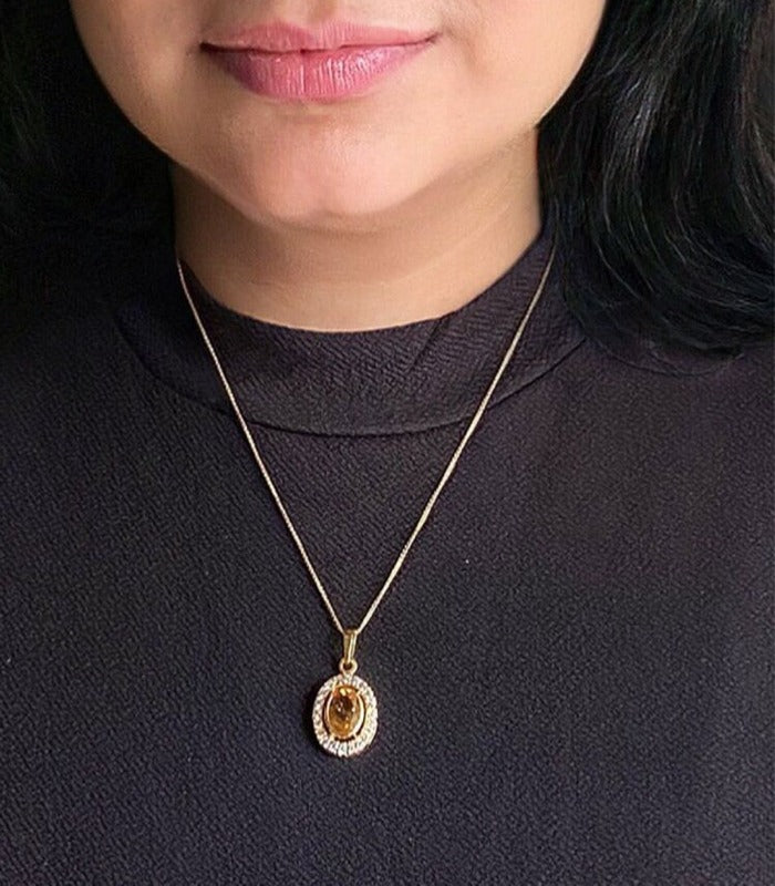 Citrine and cubic zirconia pendant necklace in gold-plated 92.5 sterling silver worn by a woman, showing its radiant, elegant look when styled.