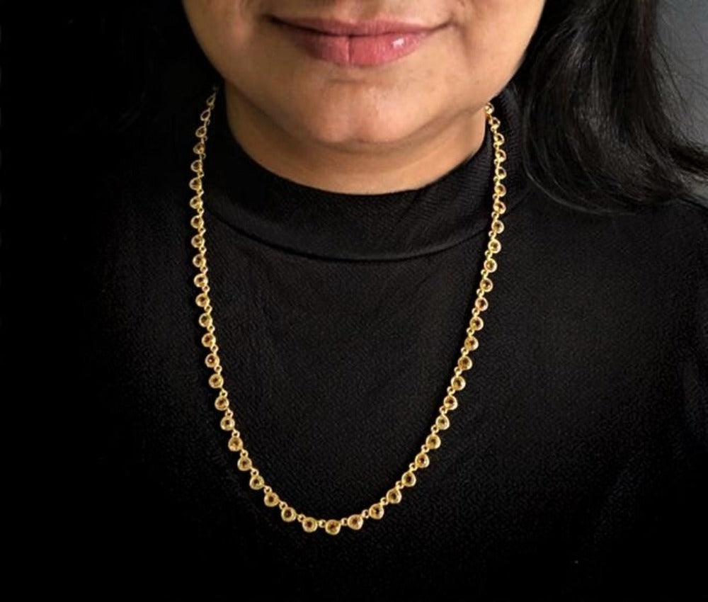 Citrine necklace in gold-plated 92.5 sterling silver worn by a woman, showing its bright, energetic look when styled.