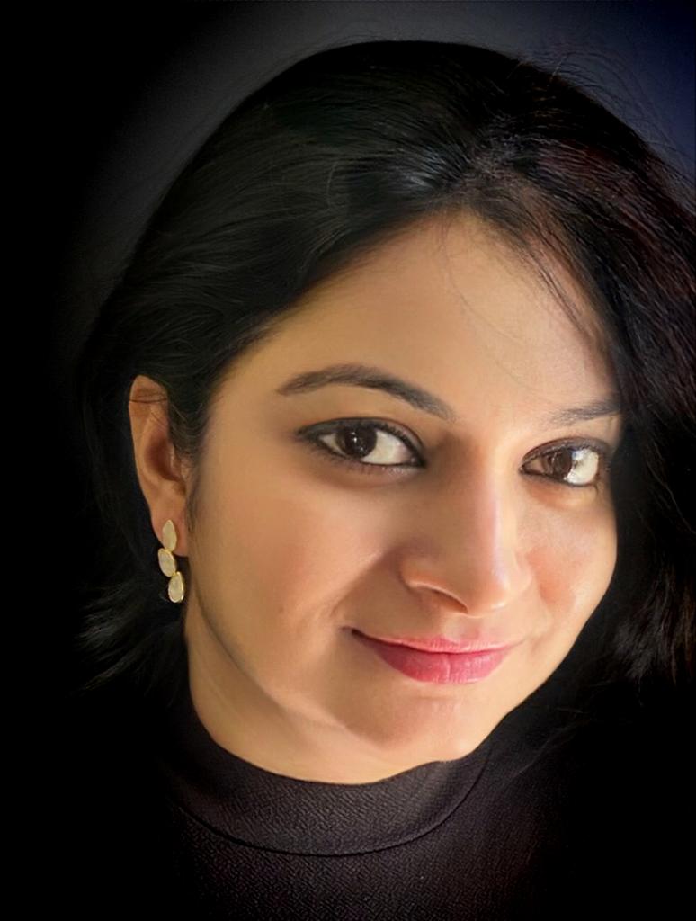 Moonstone earrings in yellow-gold plated 92.5 sterling silver worn by a woman, showing their elegant sun-kissed design when styled.