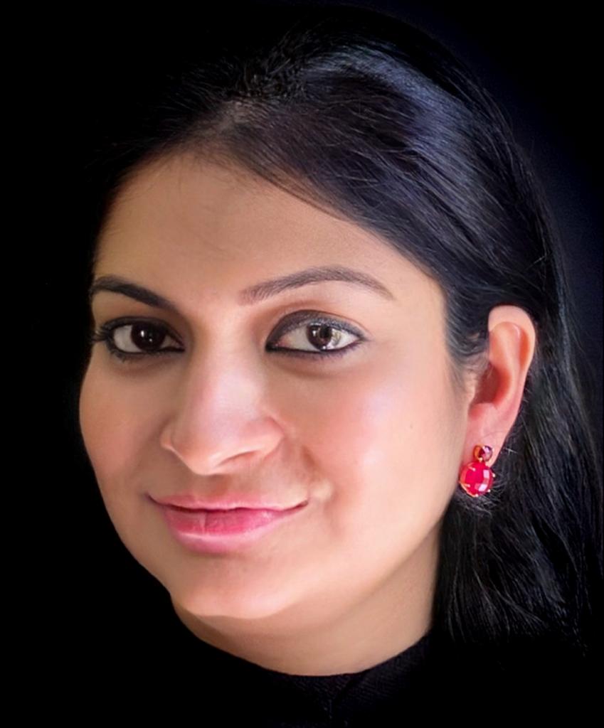 Red aventurine and garnet earrings in gold-plated 92.5 sterling silver worn by a woman, showing their bold, vibrant look when styled.
