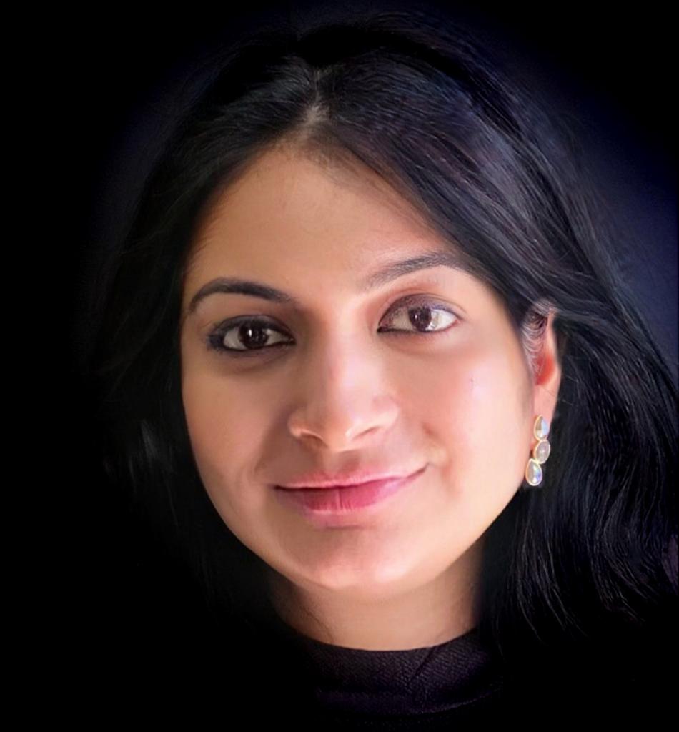 Labradorite gemstone earrings in yellow-gold plated 92.5 sterling silver worn by a woman, showing how the elegant design looks when styled.