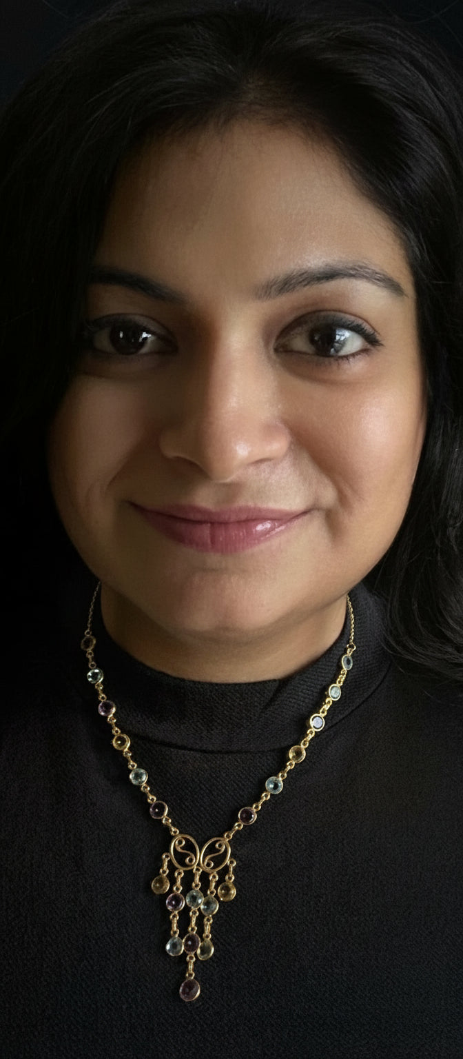 Amethyst, blue topaz, and citrine tricolor necklace in gold-plated 92.5 sterling silver worn by a woman, showing its bold, statement look when styled.