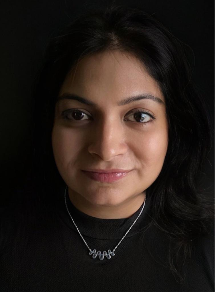 Blue topaz necklace in 92.5 sterling silver worn by a woman, showing its soft lagoon-blue elegance when styled.